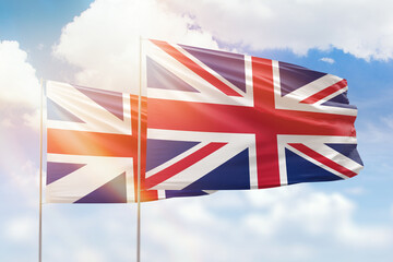 Sunny blue sky and flags of united kingdom and great britain