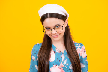 Children studio portrait on yellow background. Childhood lifestyle concept. Cute teenage girl face close up. Happy teenager, positive and smiling emotions.