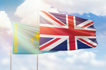 Sunny blue sky and flags of united kingdom and kazakhstan