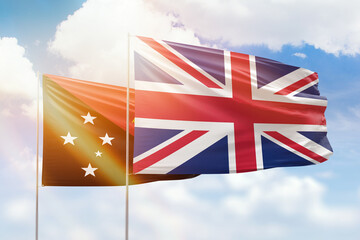 Sunny blue sky and flags of united kingdom and papua new guinea