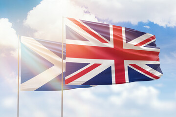 Sunny blue sky and flags of united kingdom and scotland