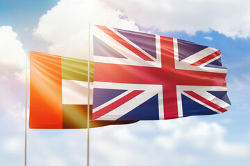 Sunny blue sky and flags of united kingdom and uae