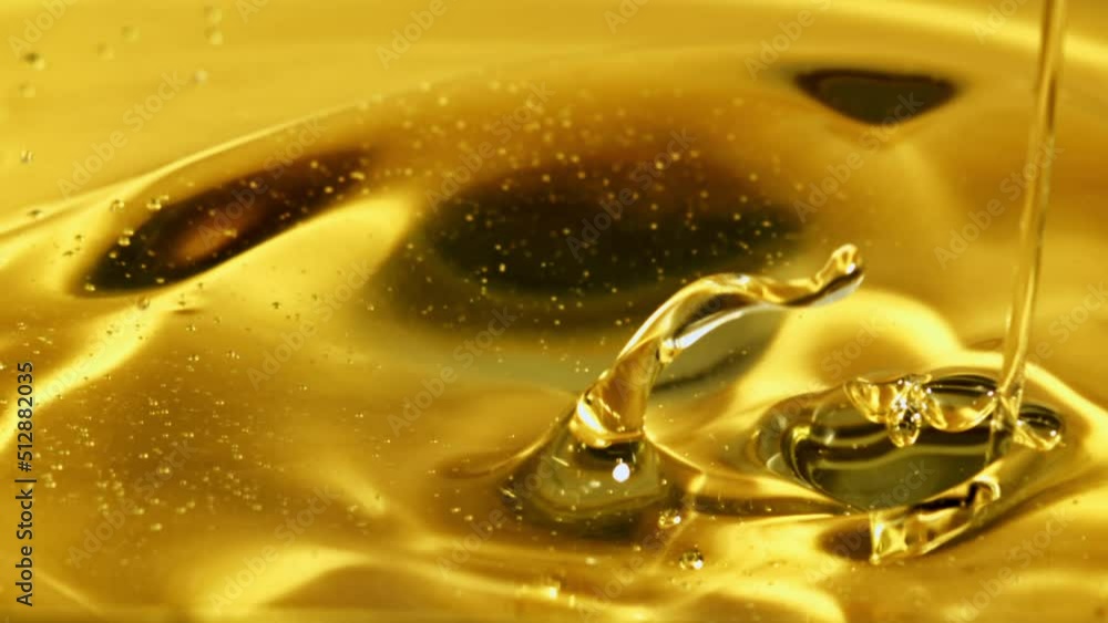 Poster a jet of olive oil flows with waves and splashes. macro background. filmed on a high-speed camera at