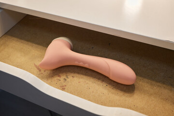 Different sex toys in open chest of drawers.