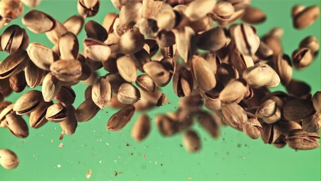 Pistachios go up and down. On the green screen. Filmed on a high-speed camera at 1000 fps.