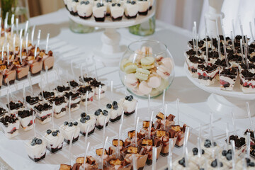 Wedding candy bar. Cakes and berries in a candy bar