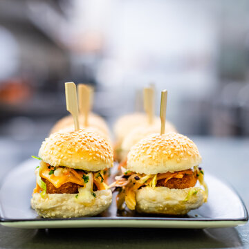 Chicken sliders, a popular party food made up of a small bun with fried chicken and slaw, selective focus