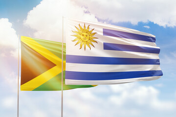Sunny blue sky and flags of uruguay and jamaica