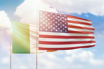 Sunny blue sky and flags of united states of america and ireland
