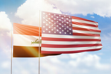 Sunny blue sky and flags of united states of america and iraq