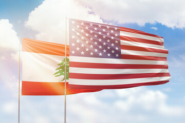 Sunny blue sky and flags of united states of america and lebanon