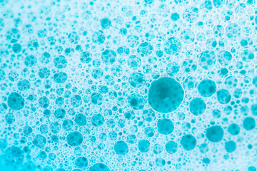 foam bubbles.Blue water with white foam bubbles.Cleanliness and hygiene background. Foam Water Soap...