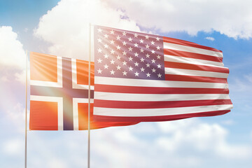 Sunny blue sky and flags of united states of america and norway
