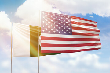 Sunny blue sky and flags of united states of america and pakistan
