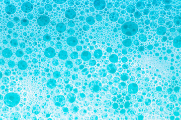 foam bubbles.Blue water with white foam bubbles.Cleanliness and hygiene background. Foam Water Soap Suds.Texture Foam Close-up. blue soap bubbles background.  - obrazy, fototapety, plakaty