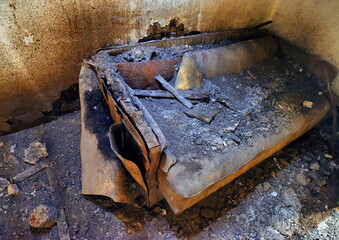 Demolished vintage couch, inside the old house.