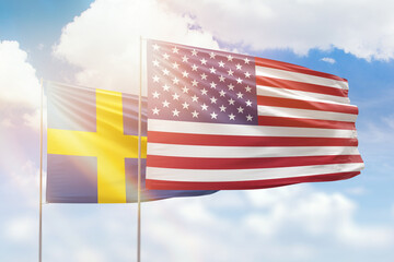 Sunny blue sky and flags of united states of america and sweden