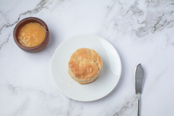 Homemade sweet scones on plate under morning sunlight. Fresh yummy tasty delicious English pastry for afternoon