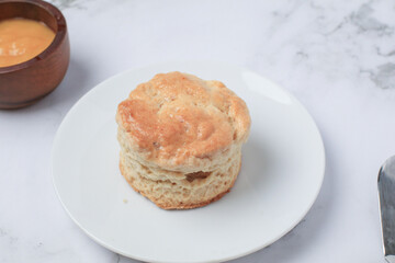 Homemade sweet scones on plate under morning sunlight. Fresh yummy tasty delicious English pastry for afternoon