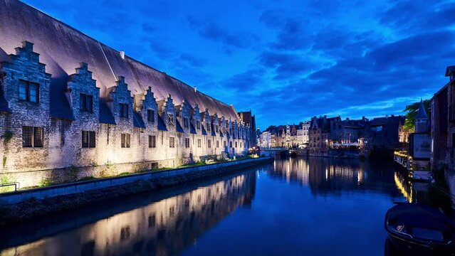 Ghent night timelapse with historic architecture of the Old Meat Market Hall reflecting in the river canal. Belgium