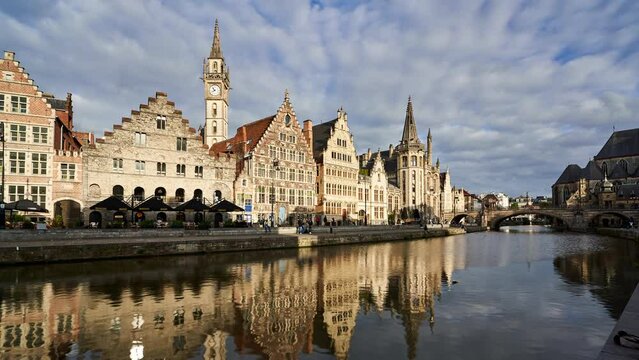 Golden hour timelapse of historic buildings in Ghent reflecting in the river canal. Belgium
