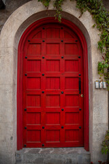 closed medieval old red door in an italian tuscany villa in Val'Quirico, Tlaxcala,  Puebla