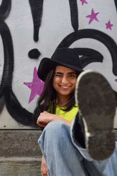 Happy Young Girl Blocking Camera With Her Foot