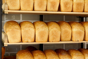 Freshly baked bread lies on the shelf for sale.