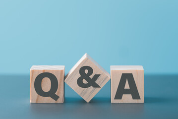 Lettering the word Q&A on a wooden block
