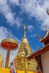 Fototapeta premium Wat Phra That Doi Kham,Chiang Mai,Northern Thailand on Septemmber 13,2019:Golden Chedi,constructed in the year 687,enshrines a sacred relic of the Buddha.