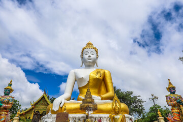 Fototapeta premium Mae Hia,Chiang Mai,Northern Thailand on Septemmber 13,2019:Sitting Buddha Statue at Wat Phra That Doi Kham.