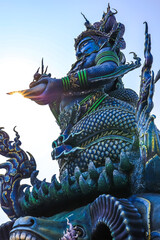 Fototapeta premium Chiang Rai Province,Northern Thailand on January 19,2020:Angellic Temple Guardians at the entrance pillars of Wat Rong Suea Ten or Blue Temple.