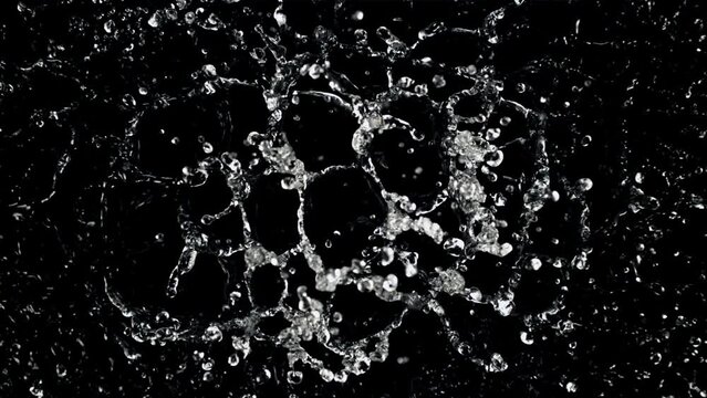 Water droplets fly up and fall down. On a black background. Filmed is slow motion 1000 fps.