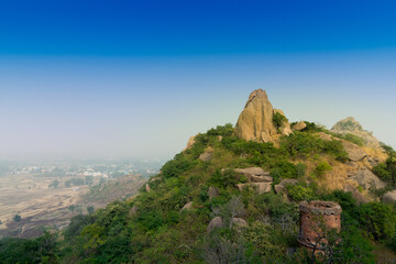 Fototapeta na wymiar Joychandi Pahar - mountain - is a hill which is a popular tourist attraction in the Indian state of West Bengal in Purulia district. Image of the top of the hill in daytime.