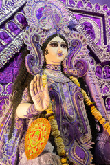 Obraz premium Blessing hand , Idol of Goddess Saraswati at Kolkata, West Bengal, India. Saraswati is Hindu goddess of knowledge, music, art, wisdom, and learning. Worshipping is done in spring in India.
