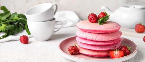 Plate with tasty pancakes and strawberry on light table