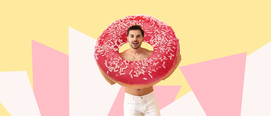 Handsome man with big tasty donut on color background
