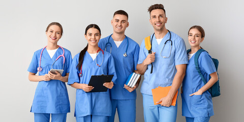 Group of medical students on light background