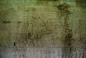 The sandstone wall carvings tell the story of the army and war on the walls of Angkor Wat Siem...