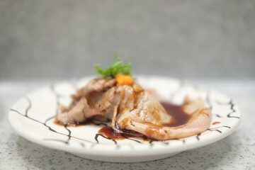 A dish of sliced and roasted Japanese beef sushi