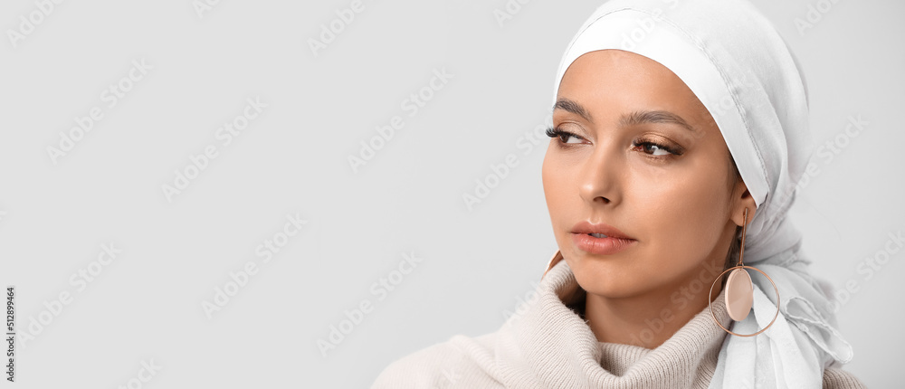 Poster portrait of beautiful muslim woman on light background with space for text