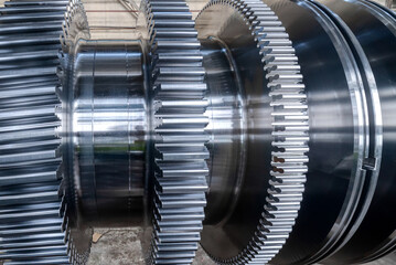 Metal shaft of steam turbine without blades in workshop