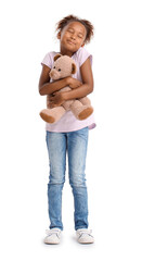 Little African-American girl with teddy bear on white background