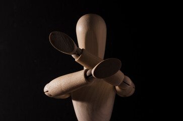 Wooden doll fighting and defending with black background
