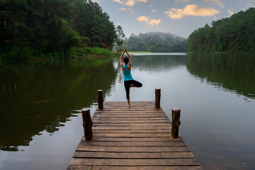 Fototapeta na wymiar Yoga Young girl or people pose balance body vital zen meditation for workout nature mountain background in morning sunrise.Lifestyle woman yoga exercise and pose for healthy life.