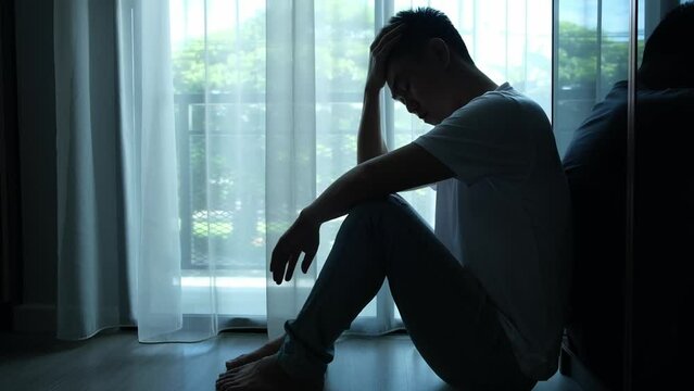 man sitting in the corner of the room have emotional and mental problems He has depression and stress from society and work. medical concept