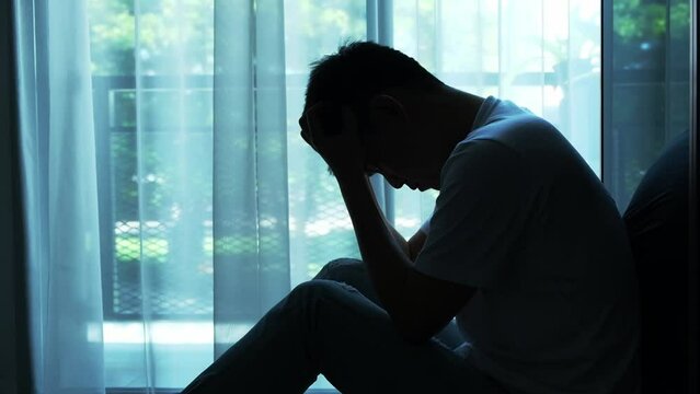 man sitting in the corner of the room have emotional and mental problems He has depression and stress from society and work. medical concept
