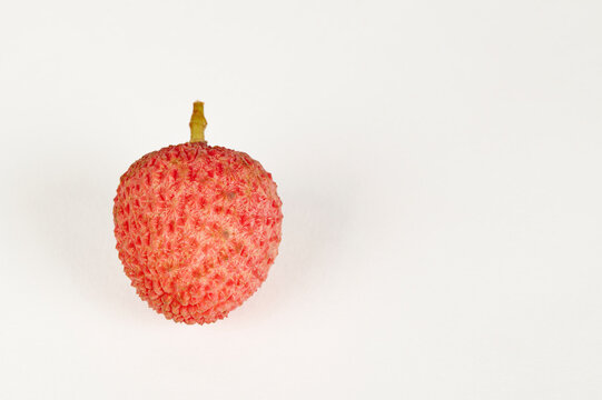 Single Litchi fruit on a white background