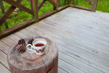 Pinecones and tea  on stump