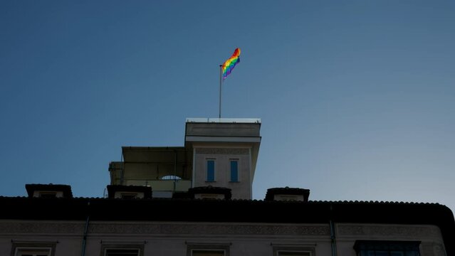 Pride flag waving on top of parliament building